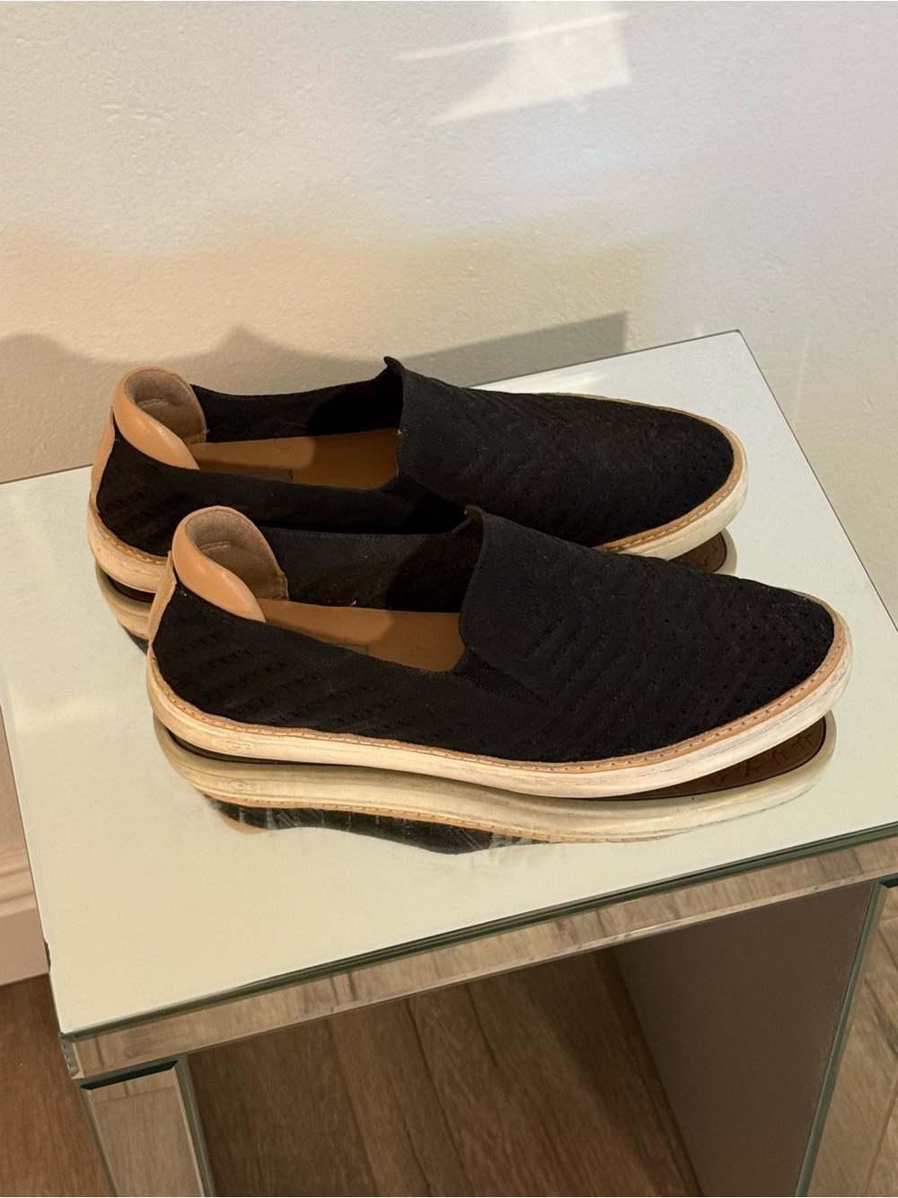 UGG Black Slip-On Loafers with Tan Heel Tab and White Midsole